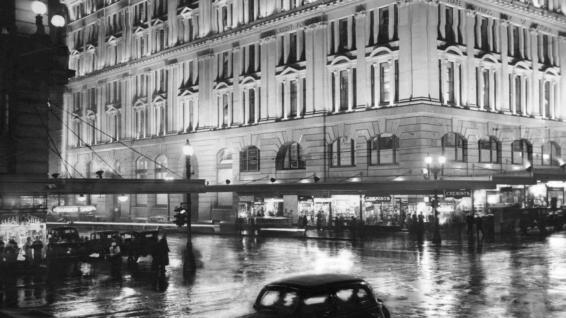 Black and white photograph of a Melbourne city street scene at night, circa 1940
