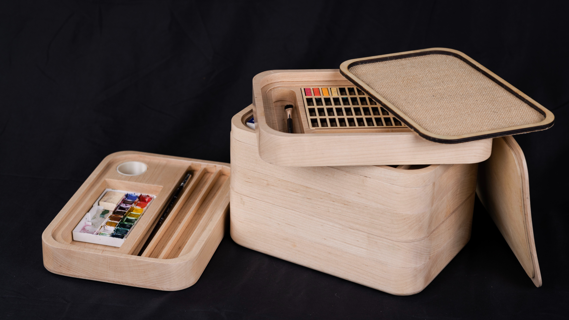 Inspired by the Japanese bento box, the Designer's Toolbox is a stackable storage container for art and design supplies.  Individual layers of the toolbox show different paintbrushes and paints.